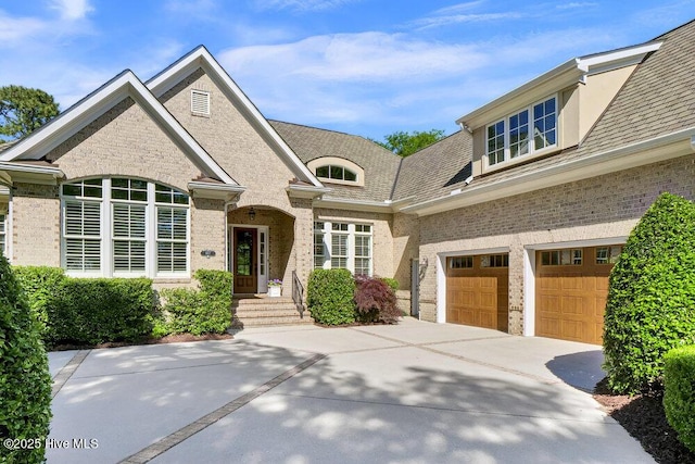 view of front of home featuring concrete driveway, brick siding, and a garage