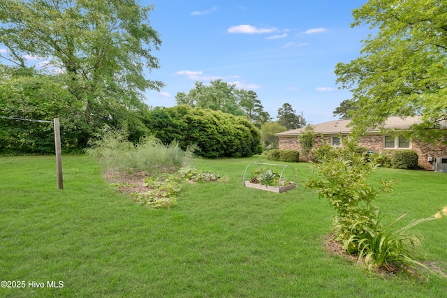 2022 Pinedale Rd, Rockingham, NC 28379 - view of green lawn with a garden