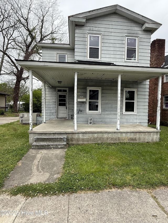 view of front facade featuring a front yard and covered porch