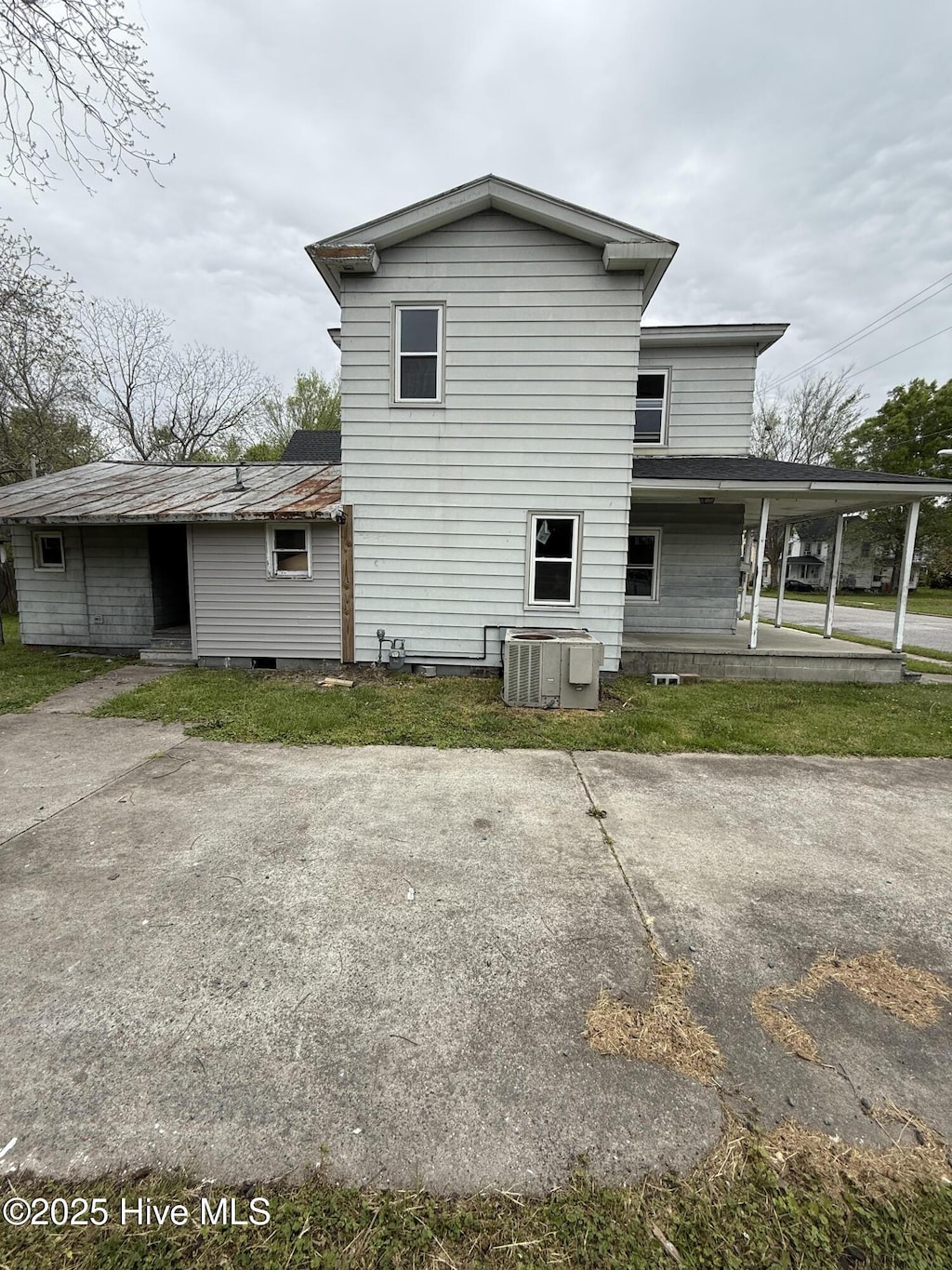 back of house featuring central air condition unit