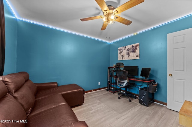 office space featuring wood finished floors, baseboards, and ceiling fan