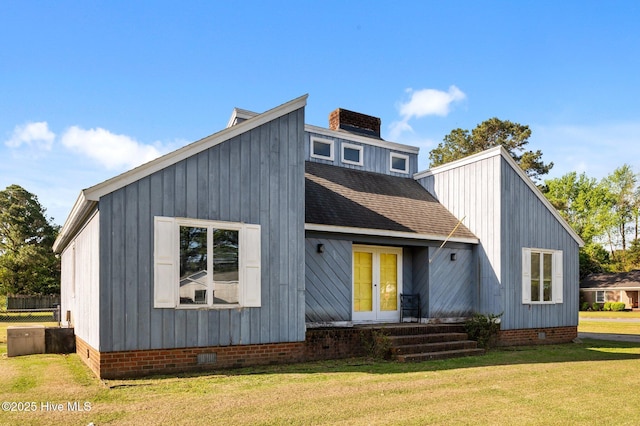 view of front of home with french doors, crawl space, a front yard, and a shingled roof