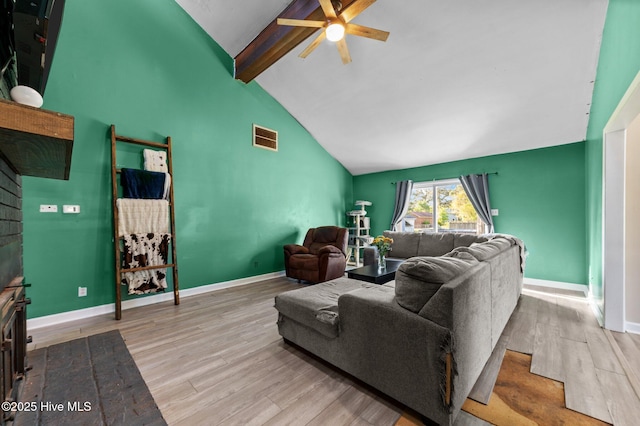 living area featuring a ceiling fan, wood finished floors, baseboards, beam ceiling, and visible vents