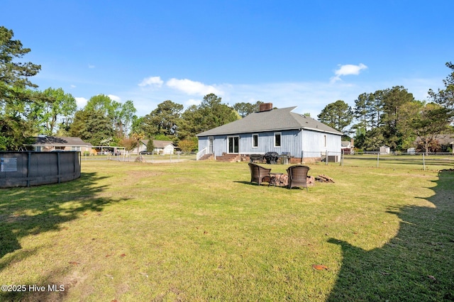 view of yard featuring a fenced backyard, an outdoor pool, and entry steps