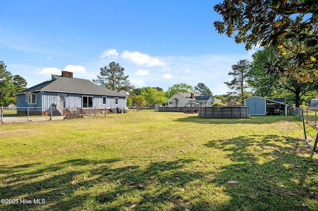view of yard with a fenced in pool and a fenced backyard