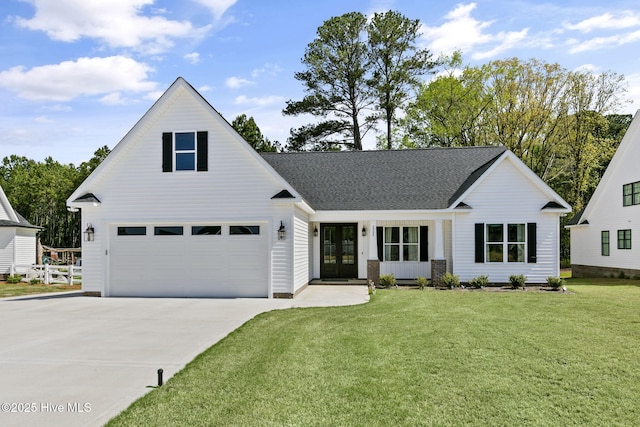 view of front of home with french doors, a front lawn, driveway, a garage, and a shingled roof