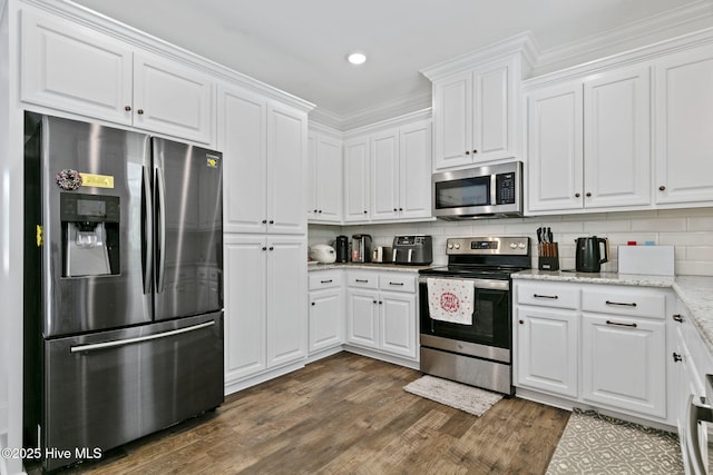 kitchen featuring stainless steel appliances, dark wood-style floors, white cabinetry, and tasteful backsplash