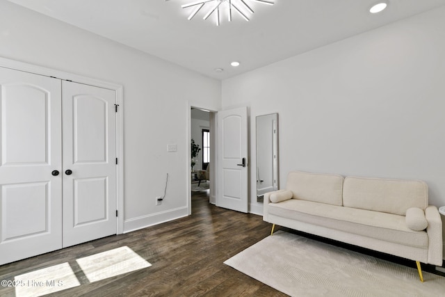 sitting room featuring baseboards, wood finished floors, and recessed lighting