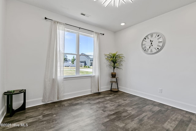 spare room featuring recessed lighting, visible vents, baseboards, and dark wood-style flooring