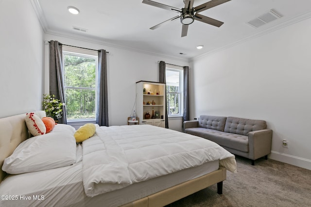 carpeted bedroom with visible vents, ornamental molding, and multiple windows