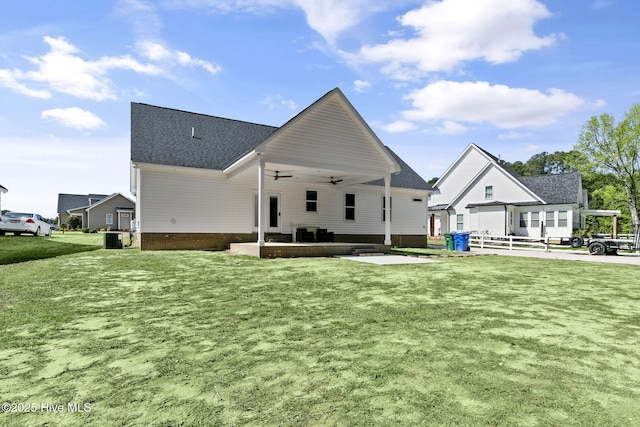 back of property with a ceiling fan, a yard, central AC unit, and a patio