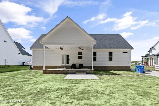 back of house featuring a lawn, roof with shingles, a patio area, and ceiling fan
