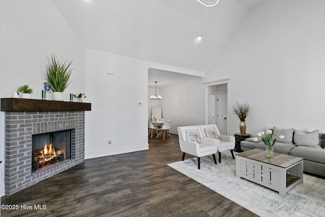living room with baseboards, a chandelier, high vaulted ceiling, wood finished floors, and a fireplace