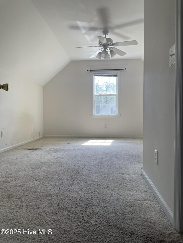 additional living space featuring baseboards, carpet, a ceiling fan, and lofted ceiling