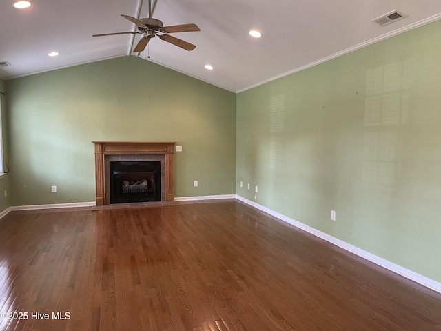 unfurnished living room featuring visible vents, ornamental molding, ceiling fan, a fireplace with flush hearth, and dark wood finished floors