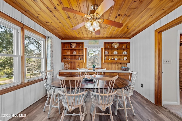 dining space featuring wooden ceiling, wood walls, ceiling fan, and dark wood finished floors