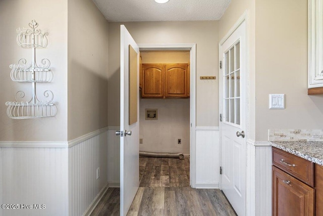 hall with wainscoting and dark wood finished floors