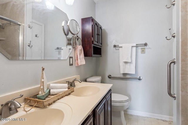 full bathroom with a shower, toilet, a sink, and double vanity