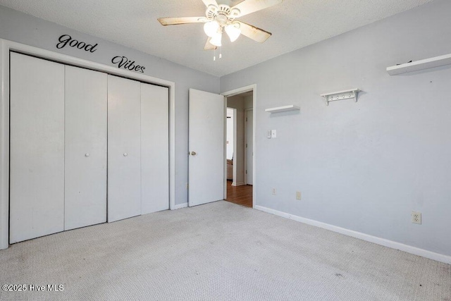 unfurnished bedroom with carpet floors, a closet, and baseboards