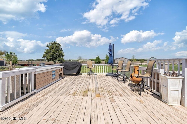 wooden terrace featuring area for grilling