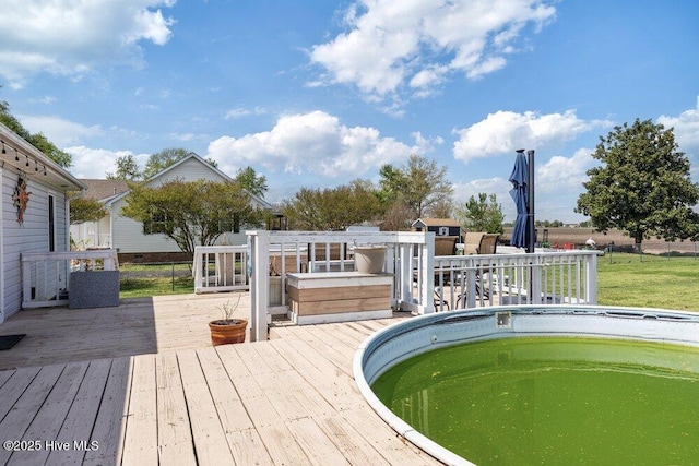 view of swimming pool featuring a wooden deck