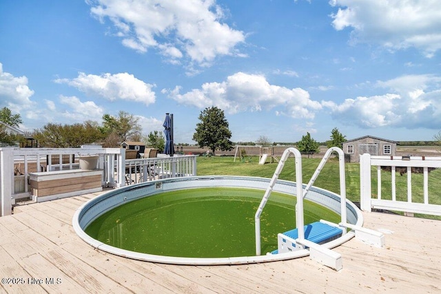 view of swimming pool with a deck