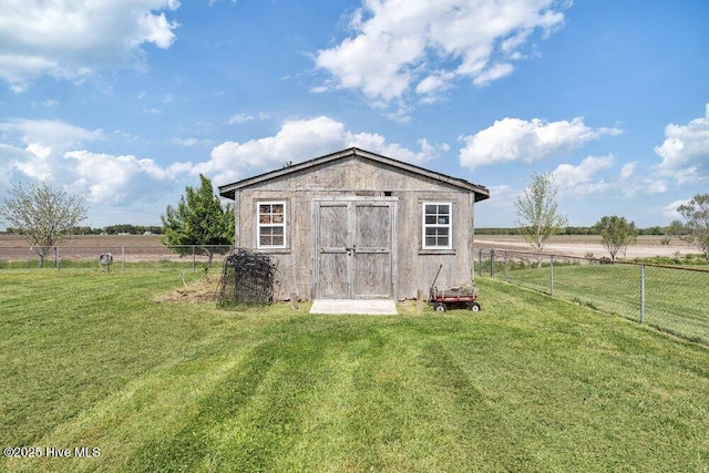 view of shed featuring a fenced backyard and a rural view