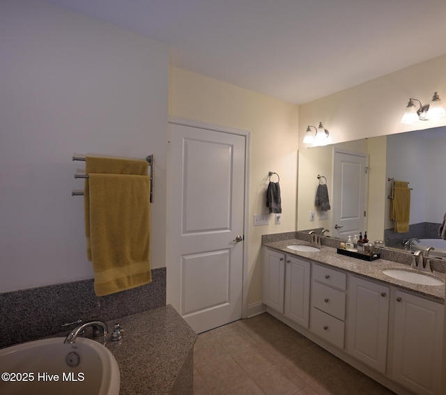 bathroom with tile patterned floors, double vanity, and a tub