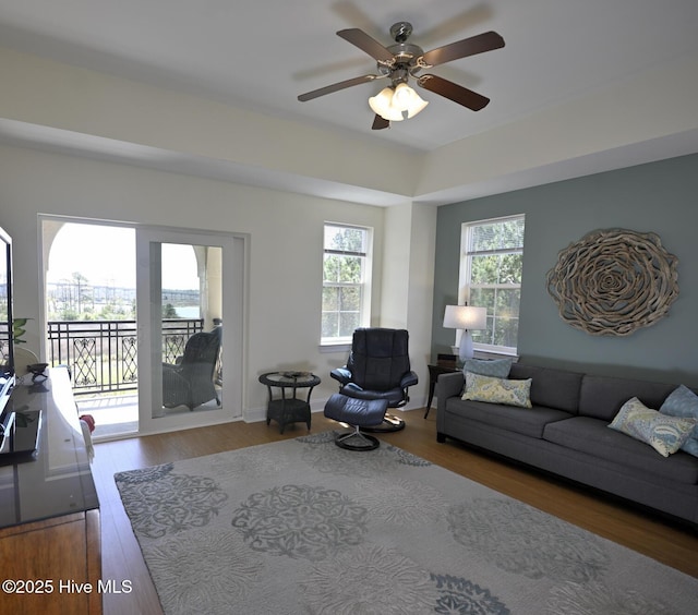 living room featuring wood finished floors and a ceiling fan