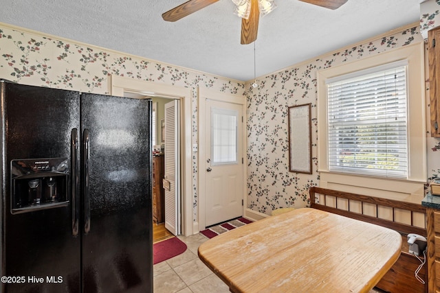dining room with wallpapered walls, light tile patterned flooring, crown molding, a textured ceiling, and ceiling fan