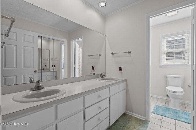 full bath featuring crown molding, tile patterned flooring, a sink, and double vanity
