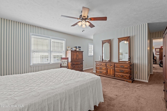 bedroom featuring wallpapered walls, baseboards, carpet flooring, and a textured ceiling