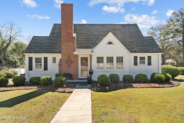 tudor house with a chimney and a front lawn