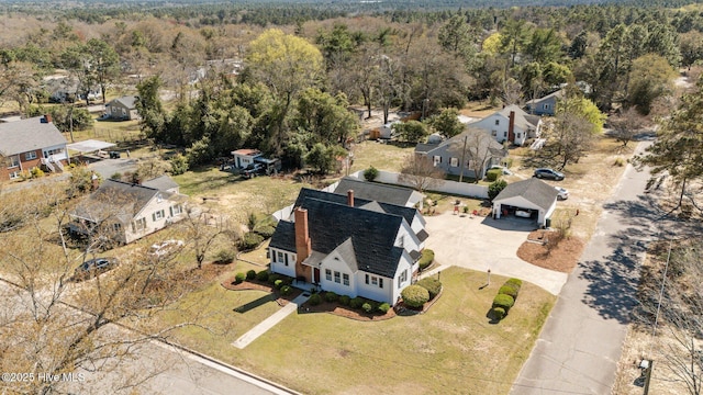 birds eye view of property with a residential view and a wooded view