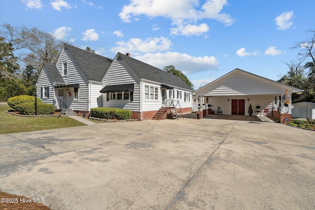 view of front of home featuring crawl space, driveway, entry steps, and a shingled roof
