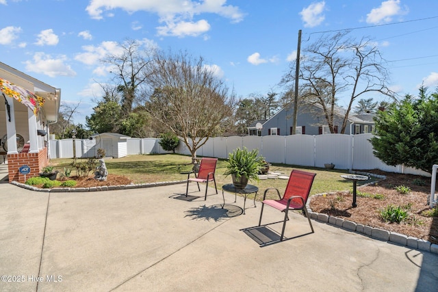 view of patio / terrace with a fenced backyard, an outbuilding, and a storage shed