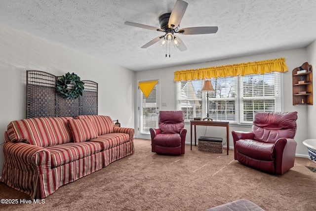 living room featuring a ceiling fan, carpet flooring, and a textured ceiling