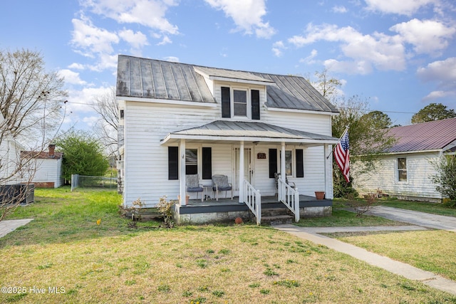 302 N Saratoga St, Stantonsburg, NC 27883 - view of front of house featuring a front yard, a porch, a standing seam roof, and metal roof