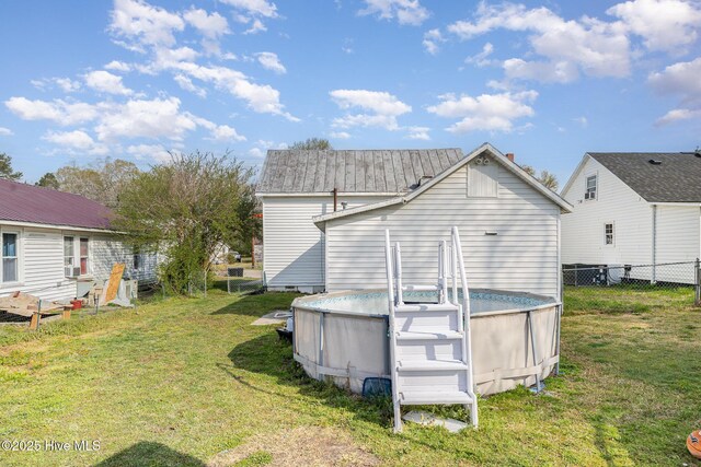 302 N Saratoga St, Stantonsburg, NC 27883 - back of property featuring a yard, an outdoor pool, and fence