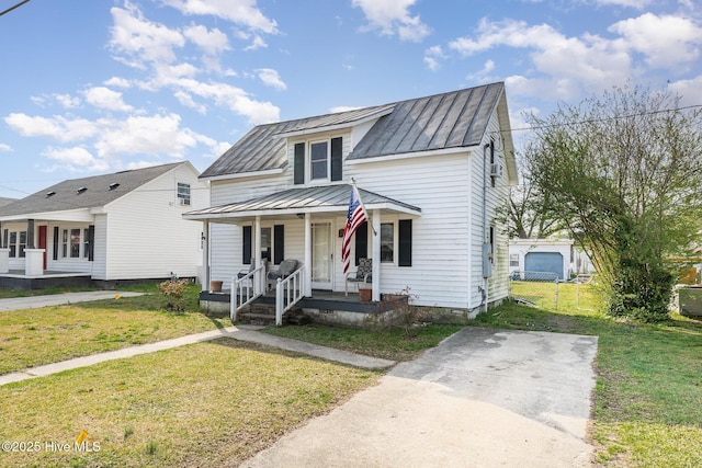 302 N Saratoga St, Stantonsburg, NC 27883 - view of front of house featuring a standing seam roof, covered porch, a front yard, and metal roof