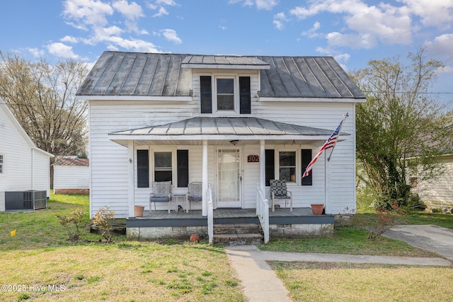 302 N Saratoga St, Stantonsburg, NC 27883 - view of front of home featuring a standing seam roof, a front lawn, central AC, and metal roof