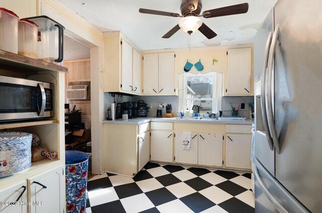 302 N Saratoga St, Stantonsburg, NC 27883 - kitchen with light floors, ceiling fan, light countertops, appliances with stainless steel finishes, and a wall unit AC