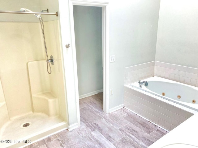 4105 Breezwood Dr Unit 203, Wilmington, NC 28412 - full bath featuring a jetted tub, a shower stall, and baseboards