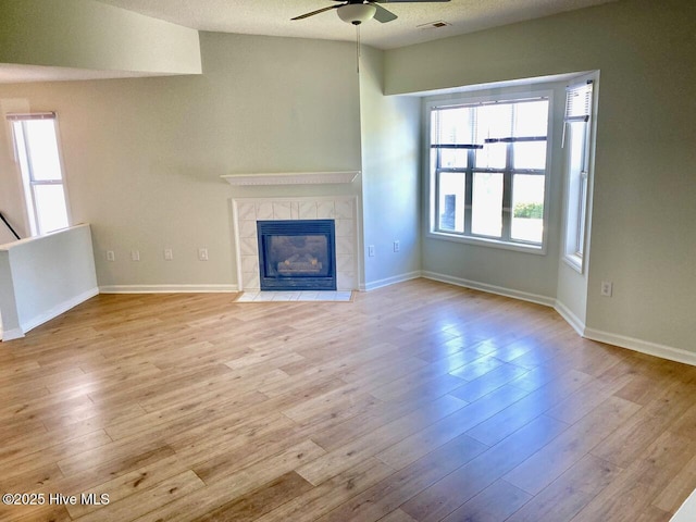 4105 Breezwood Dr Unit 203, Wilmington, NC 28412 - unfurnished living room featuring ceiling fan, wood finished floors, and a fireplace