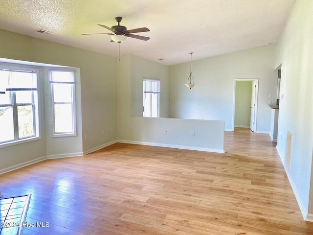 4105 Breezwood Dr Unit 203, Wilmington, NC 28412 - empty room with light wood-type flooring, a ceiling fan, baseboards, a textured ceiling, and lofted ceiling