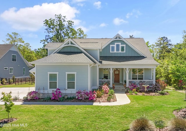 3981 Bay Colony Rd NE, Leland, NC 28451 - craftsman-style house with board and batten siding, a front yard, a porch, and a shingled roof