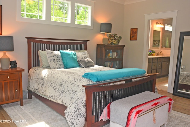 3981 Bay Colony Rd NE, Leland, NC 28451 - bedroom with wood finished floors, multiple windows, and ensuite bath