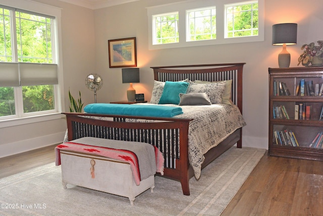 3981 Bay Colony Rd NE, Leland, NC 28451 - bedroom with wood finished floors, multiple windows, and baseboards