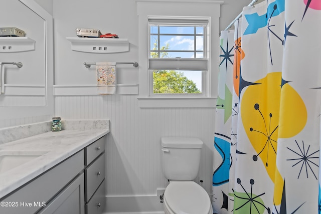 3981 Bay Colony Rd NE, Leland, NC 28451 - full bathroom featuring vanity, toilet, wainscoting, and curtained shower