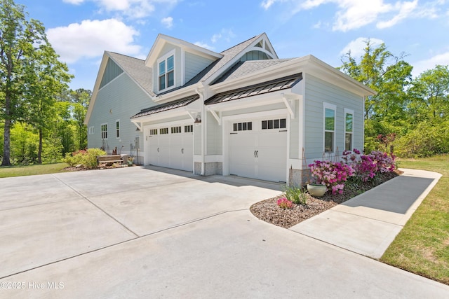 3981 Bay Colony Rd NE, Leland, NC 28451 - view of side of property with a standing seam roof, driveway, a shingled roof, an attached garage, and metal roof